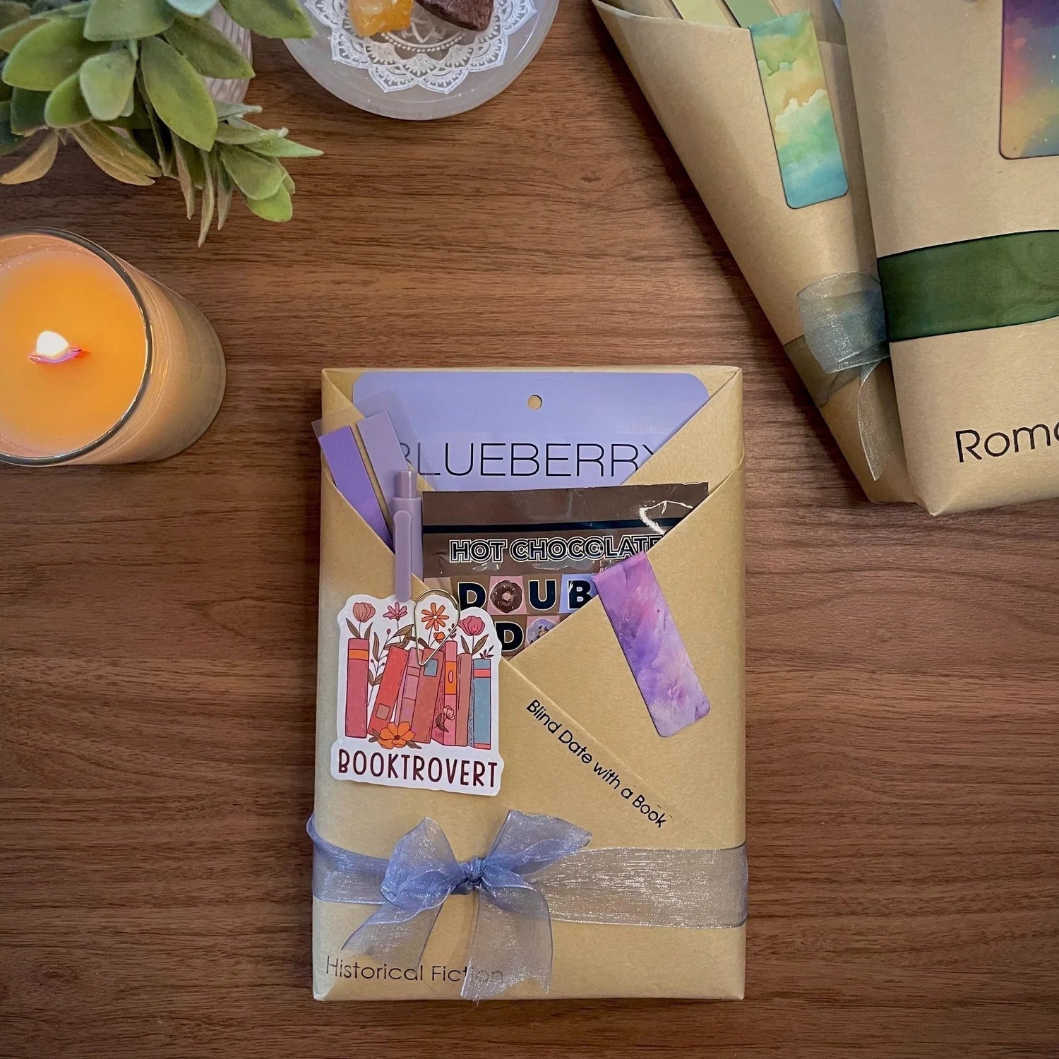 Book-themed gift box with decorative elements on a wooden surface.